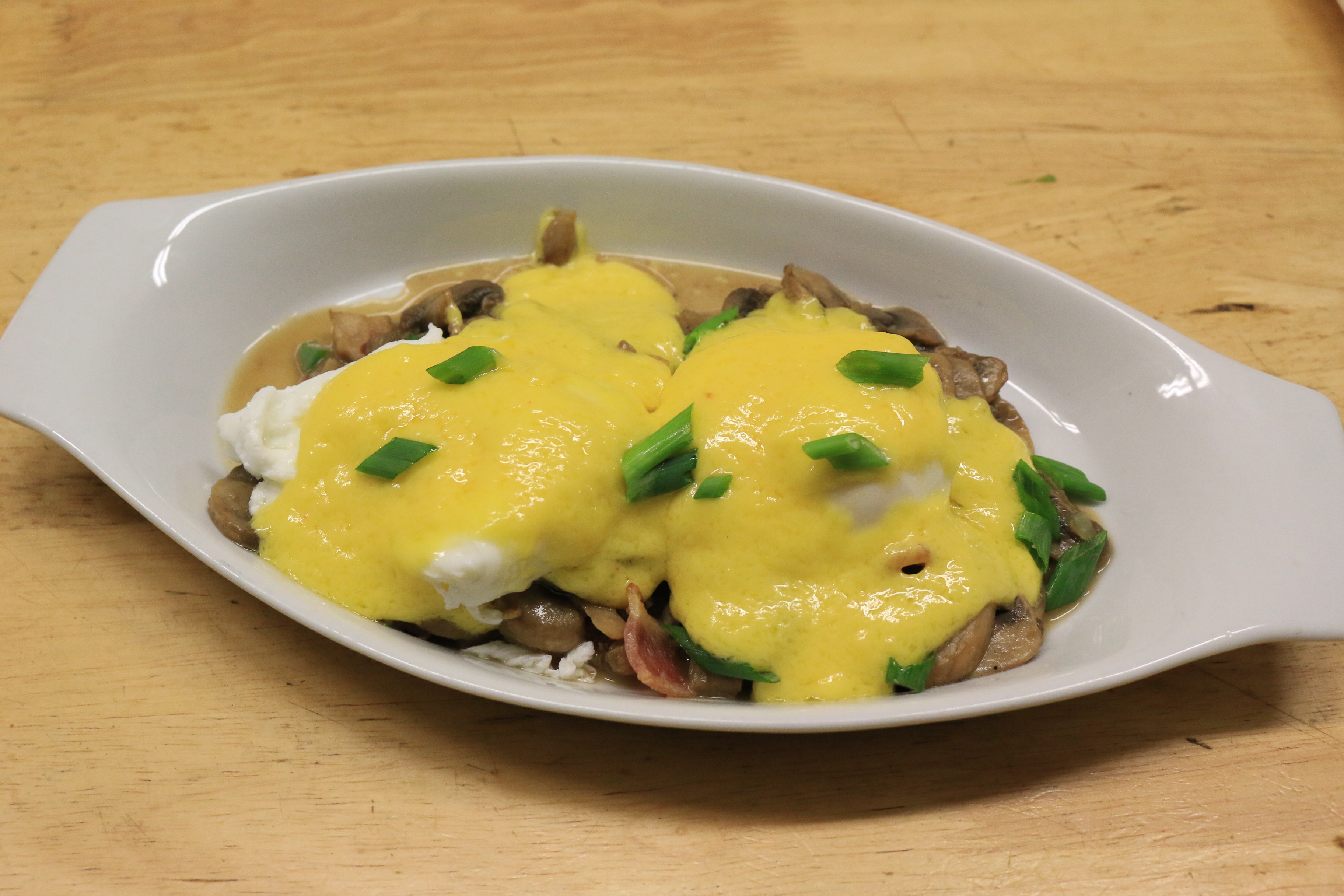 Eggs Benedict Over Mushrooms and Bacon