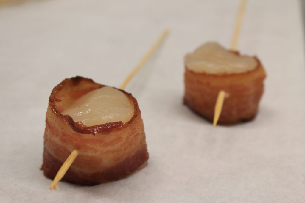 Baopn wrapped scallops are prepared for cooking.