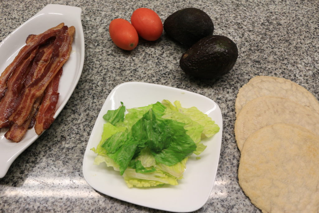 Fresh veggies prepare themselves for the paleo BLT wrap that is about to happen.