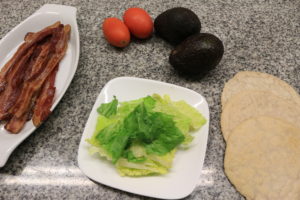 Fresh veggies prepare themselves for the paleo BLT wrap that is about to happen.